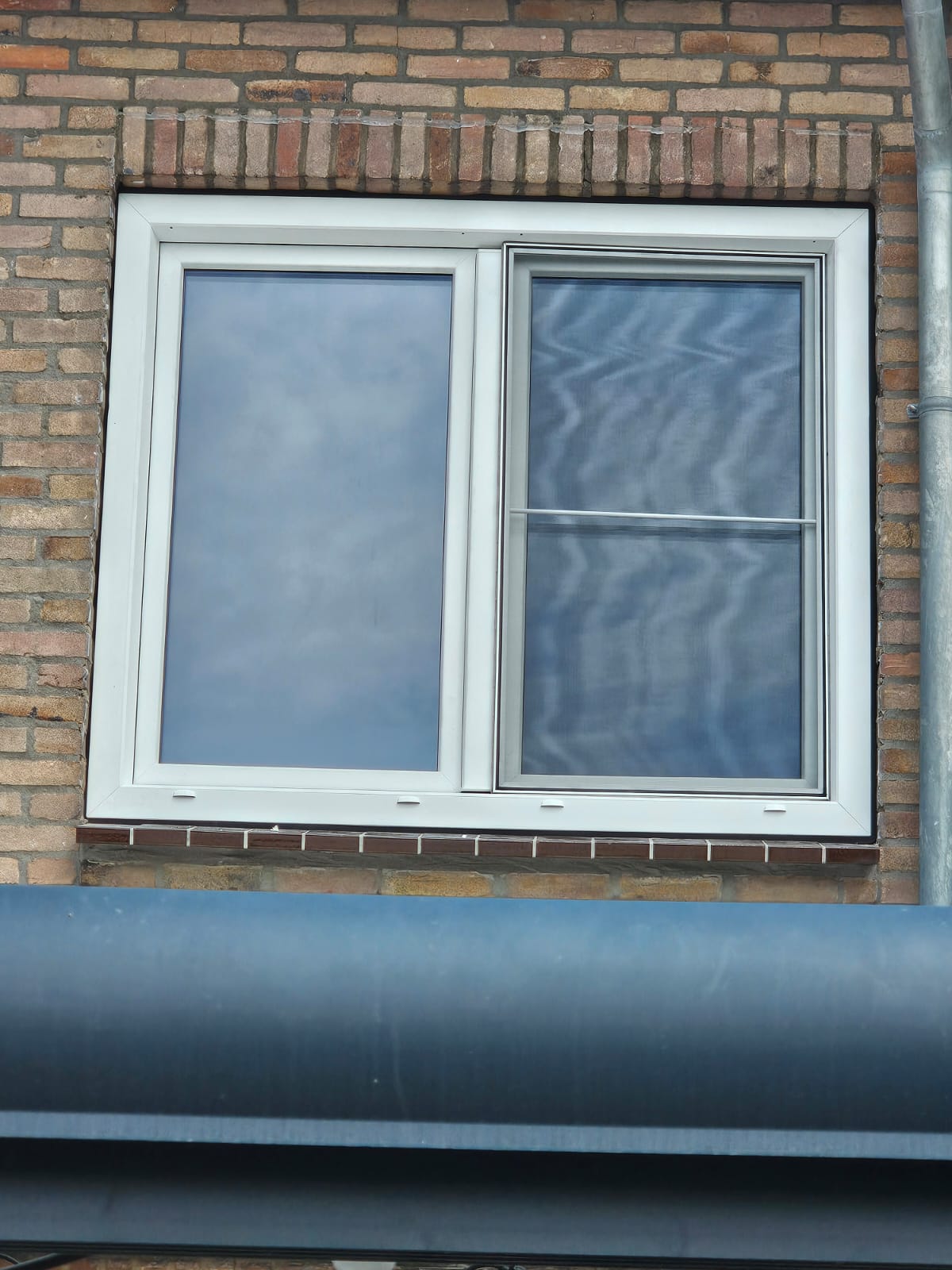uPVC window frame with tilt-and-turn sash and insect screen in a home in Veldhoven