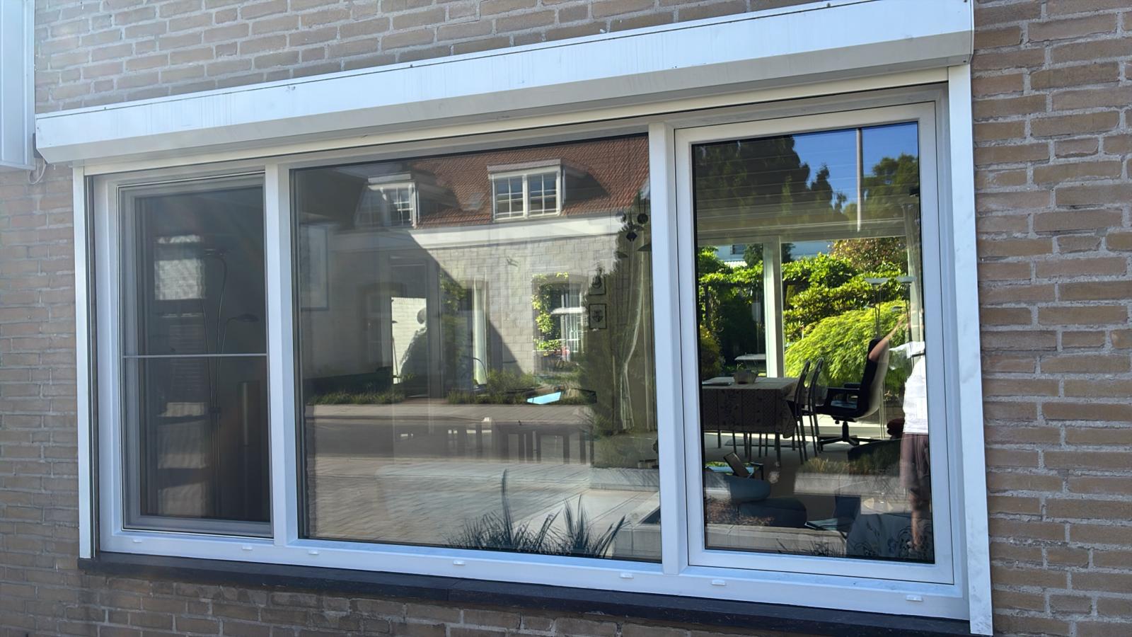 Sliding patio door with roller shutter installed at the rear of a house in Eindhoven